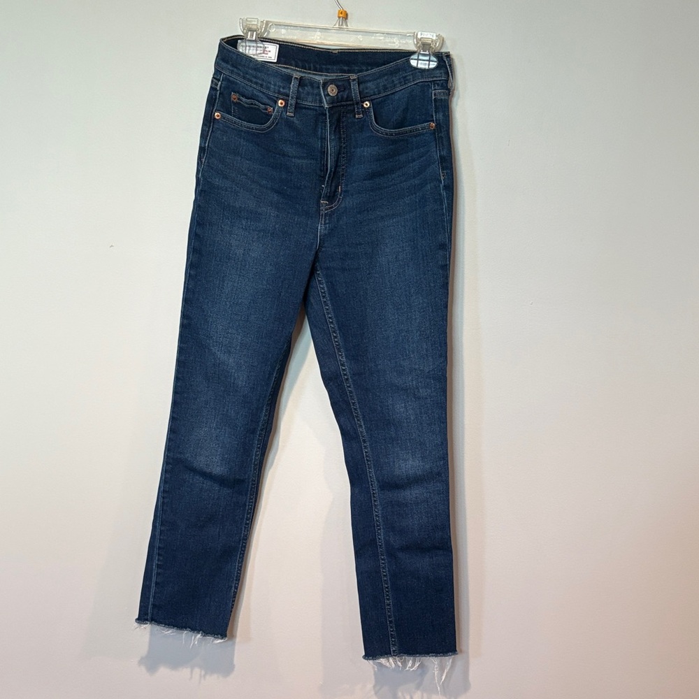 Women's distressed hem blue jeans